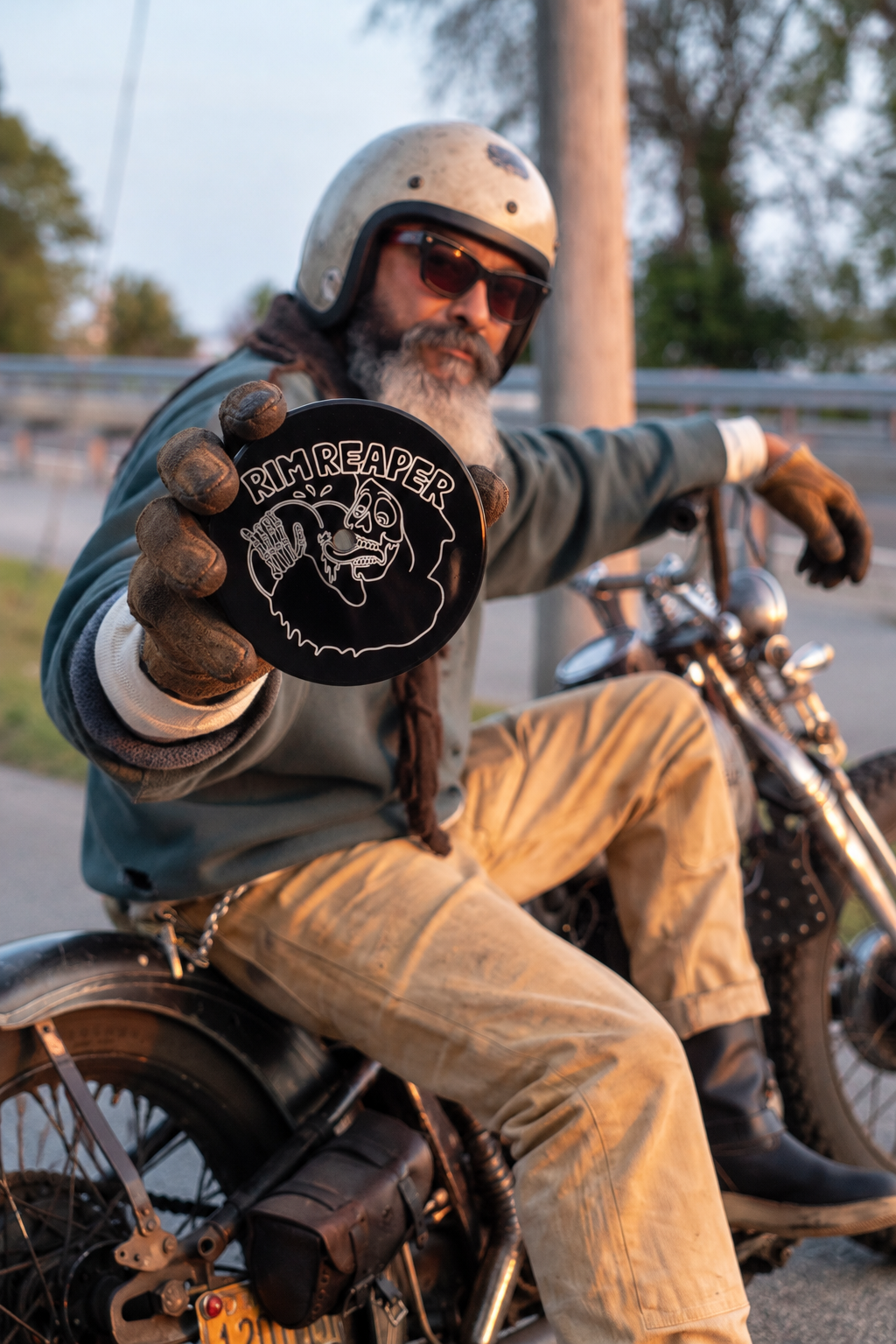 Motorcyclist holding a Rim Reaper air cleaner cover